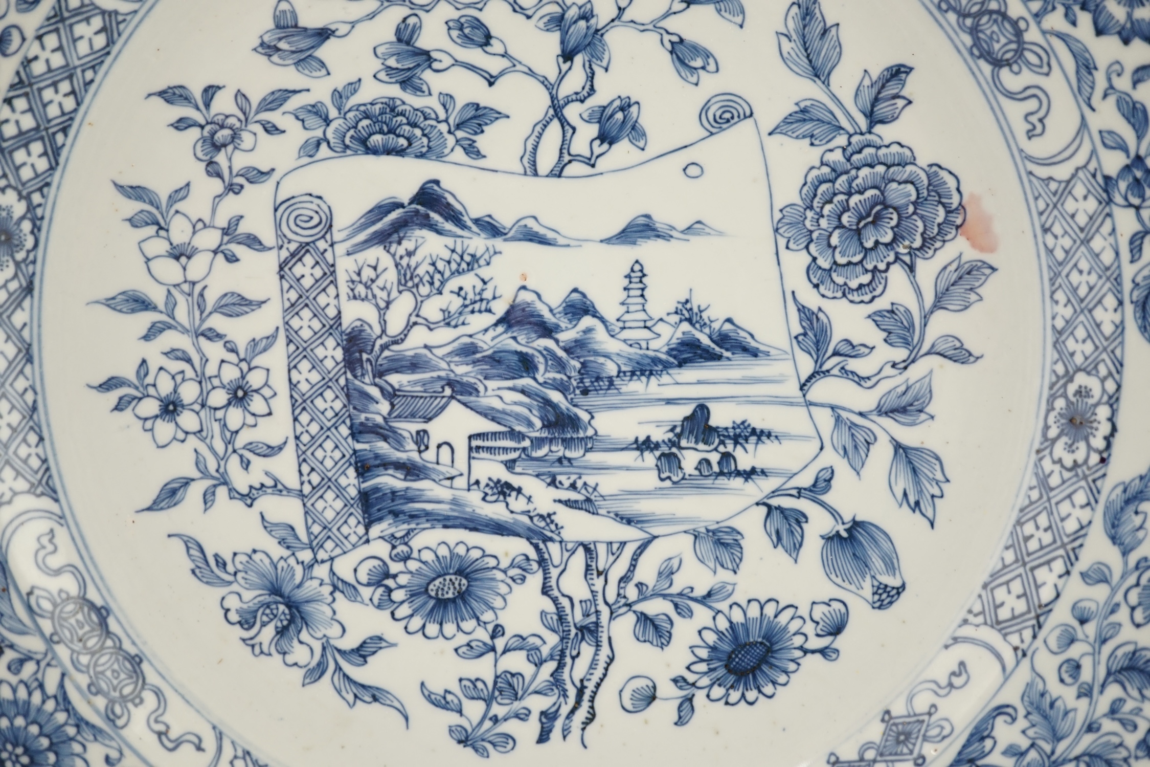 A Chinese blue and white 'scroll and blossom' charger, Qianlong period